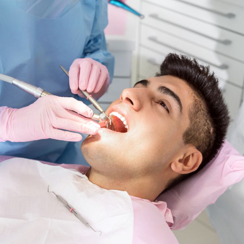 Root Cannel treatment A smiling man sits in a dental chair