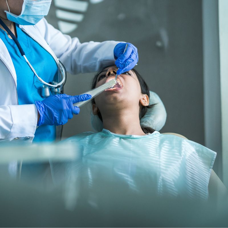 Azad Dentals Painless RCT A smiling man sits in a dental chair