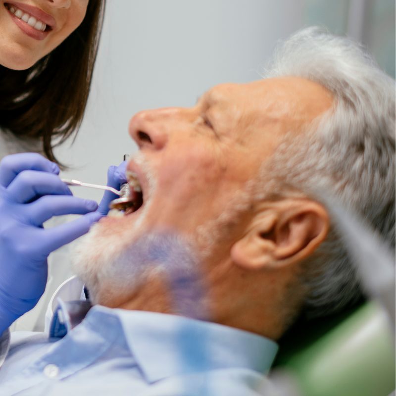 Azad Dentals Patna Molar Extraction indian patient A smiling man sits in a dental chair