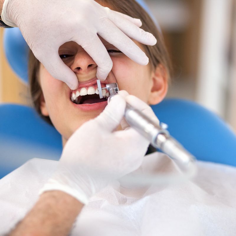 Dental Cleaning (1) A smiling man sits in a dental chair