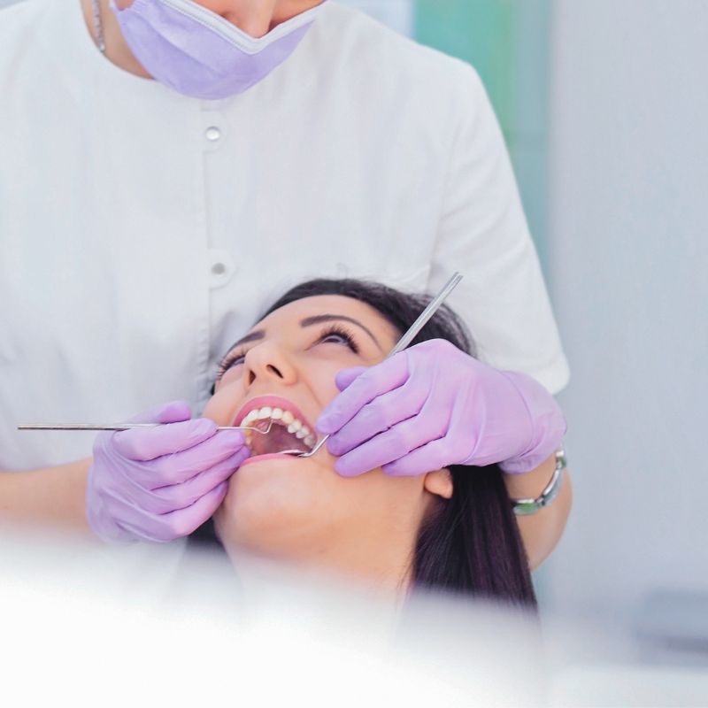 local anesthesia shot before surgery A smiling man sits in a dental chair